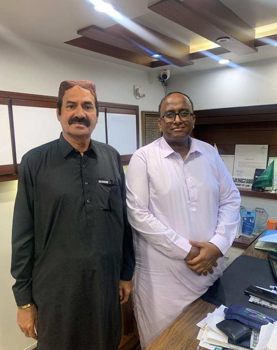 Ghulam Shabbir Babar with a colleague in an office